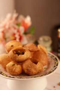Crispy and flavorful homemade Indian golgappa served on a decorative plate.